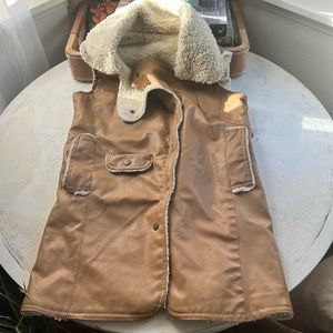 Vintage vest driftwood color with lambs wool lining, very old. Has a small nick